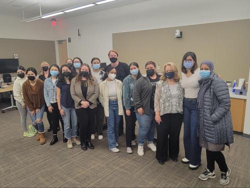 Group photo of people standing indoors