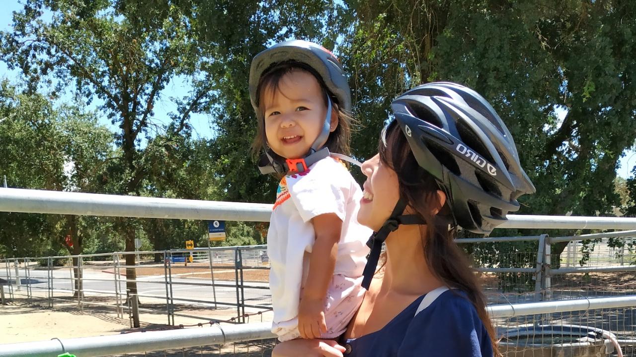 Loma Pongmee at the UC davis campus with her child, bike riding