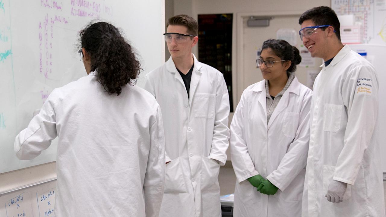 undergraduates in lab coats in the bio design lab