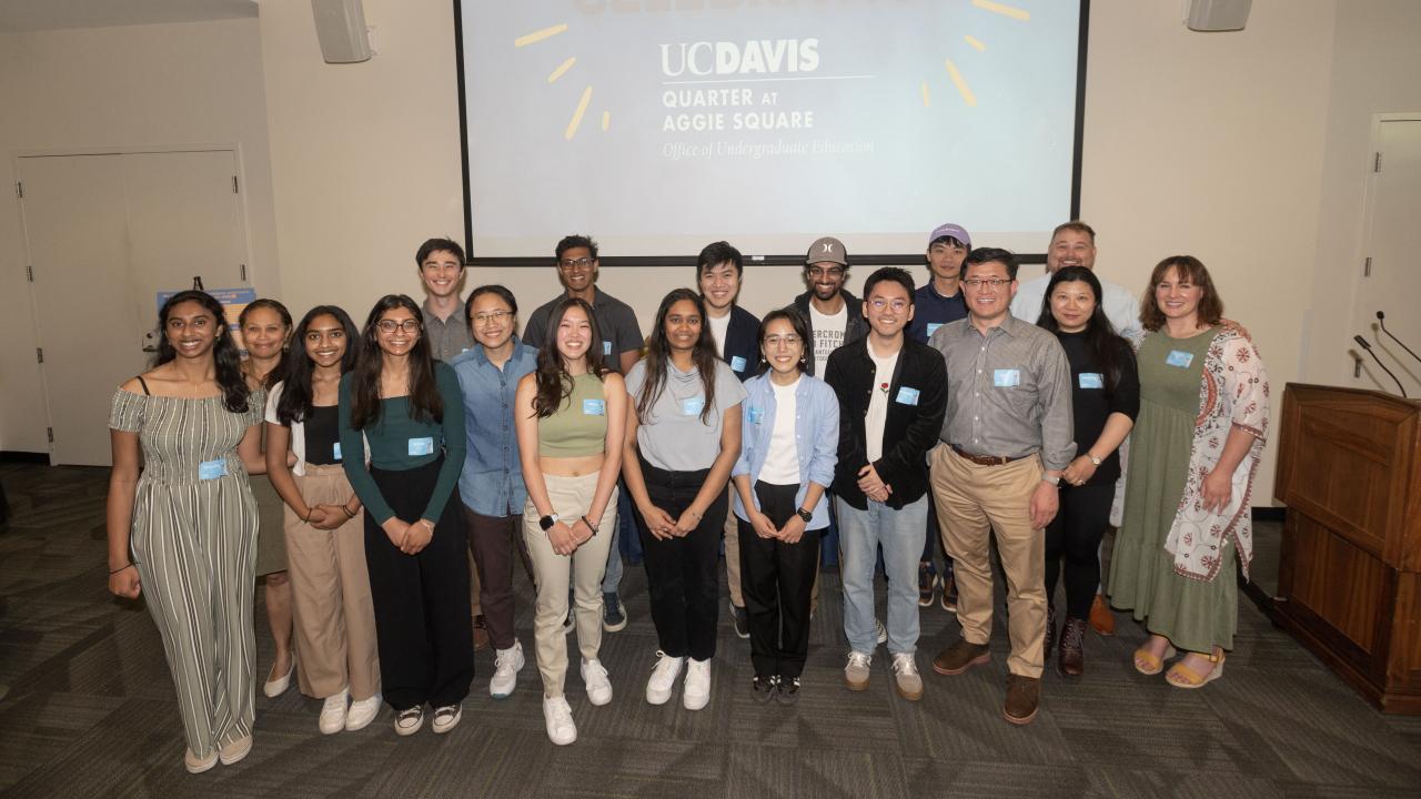 A group of people posing for a photo. Group is primarily UC Davis students.