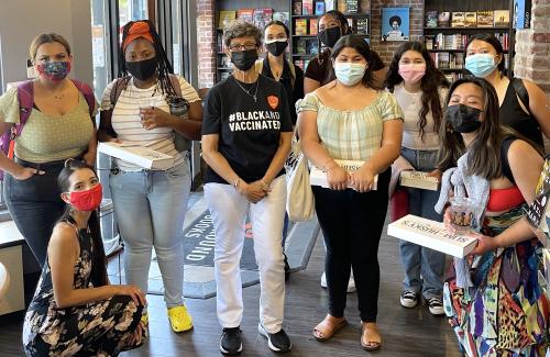 Quarter at Aggie Square Students at Underground Books with Mother rose