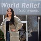 Female student stands in front of World Relief offices